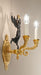 Gold Wall Sconce with Matte Dark Bronze Figurine Detail