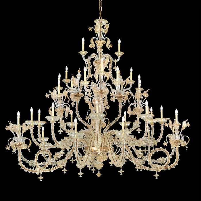 Tiered Rezzonico-style Murano glass chandelier with clear curved arms, gold detailing and decorative glass leaves against a black background