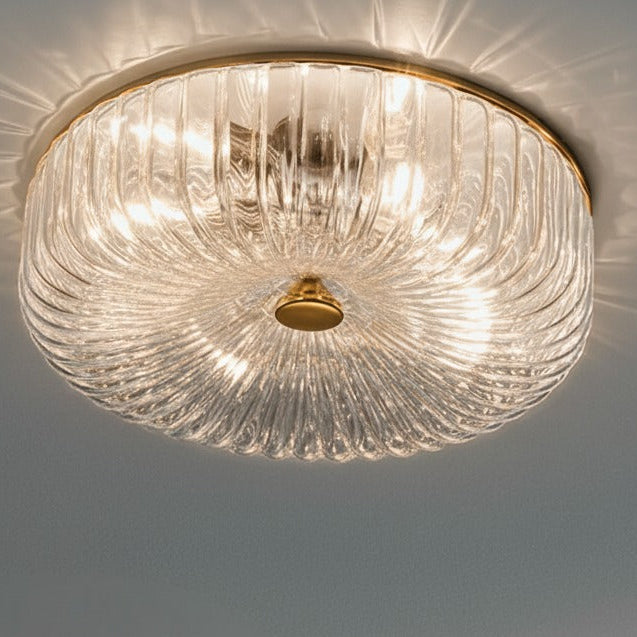 Ceiling light fixture with clear glass shade and gold frame