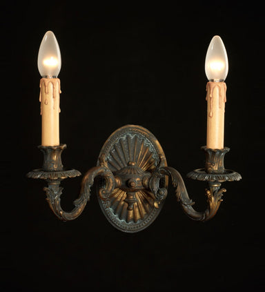 Louis XV-style antiqued brass two-light wall sconce