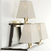 Understated modern brass wall light with gold shades