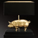 24 carat gold 'lucky pig' table light with black shade