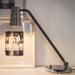 Tall modern bronze or chrome table light with silk rope detail
